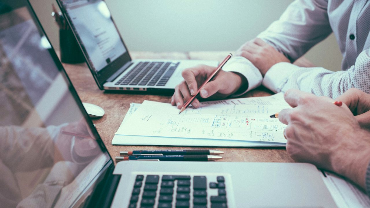 Documents and laptop on a desk for reviewing offers